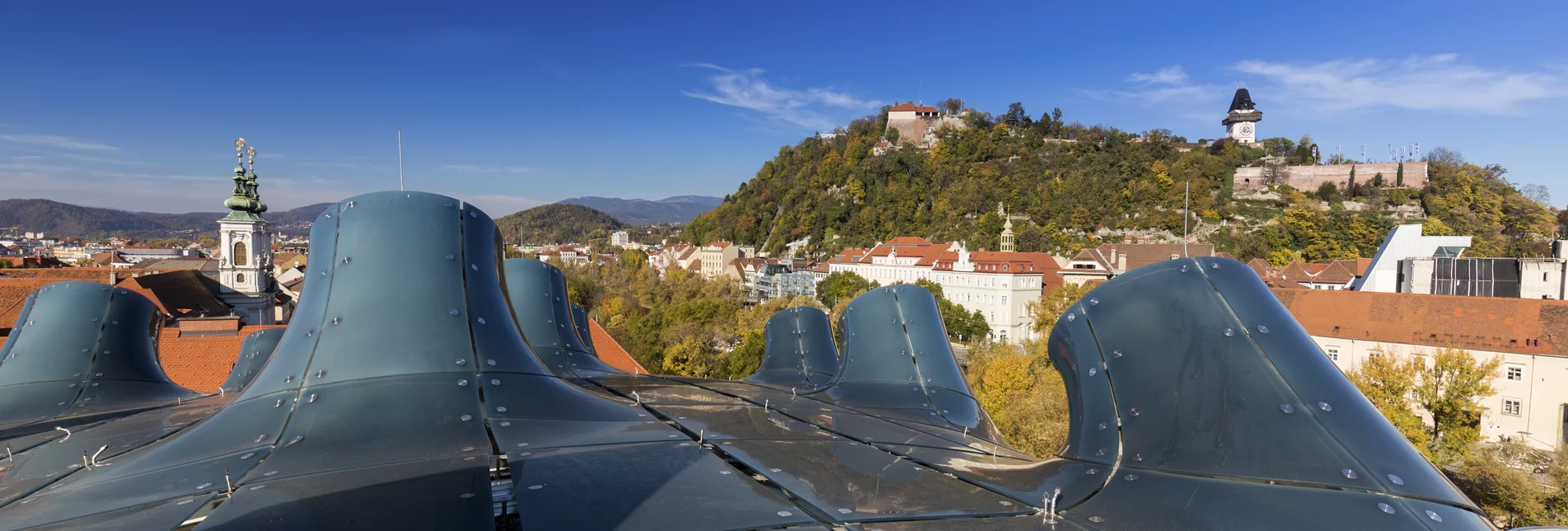 Graz with Kunsthaus and Schlossberg together with Clock Tower and Mariahilfer Church | © Steiermark Tourismus | Harry Schiffer