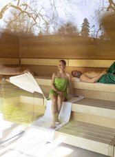 Pärchen genießt einen geführten Aufguss mit Blick in den Kurpark in der Therme der Ruhe Bad Gleichenberg