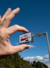 Hand focused lust for life sign with half full glass of red wine on Vulkanland Route 66