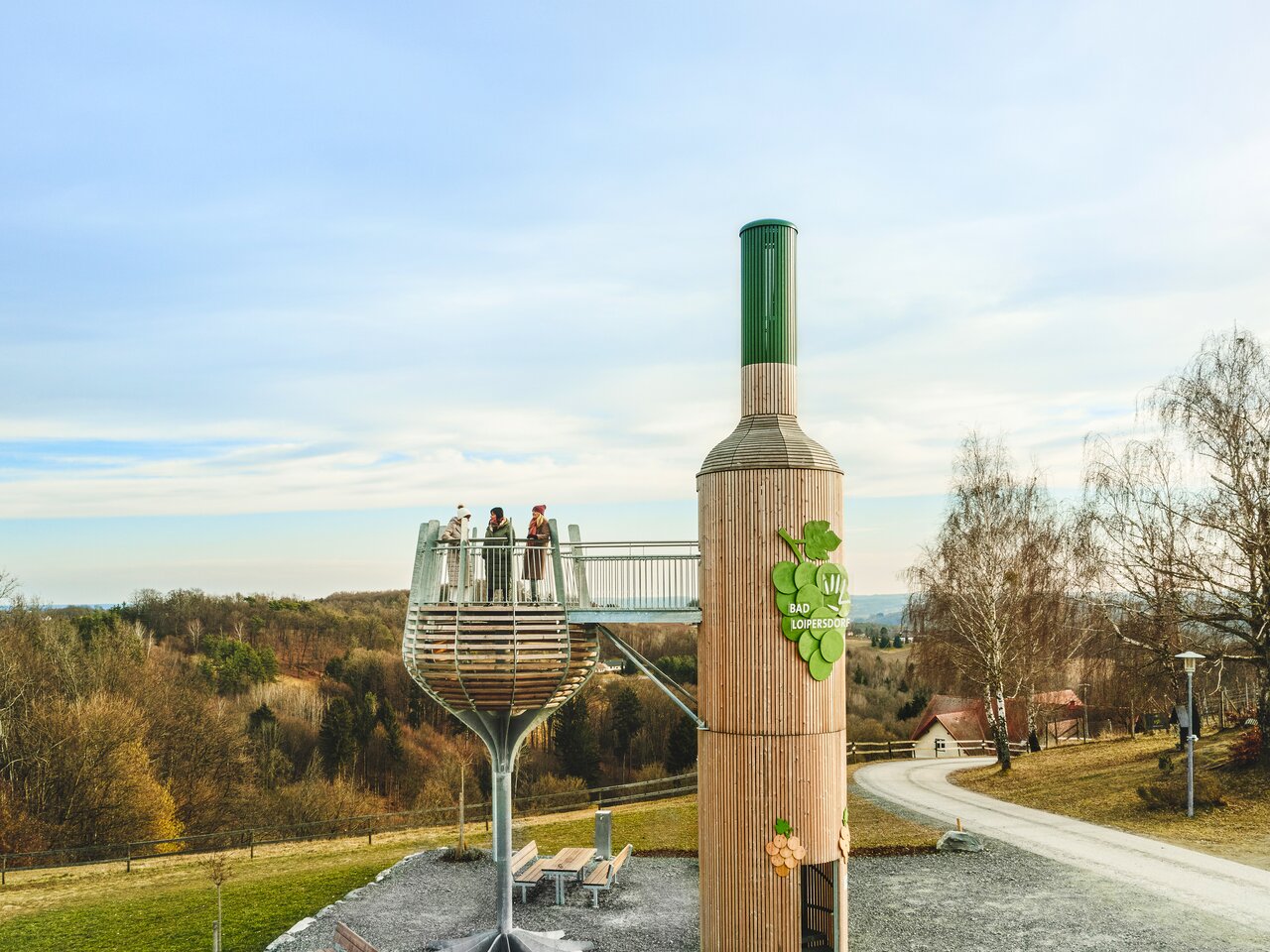 Three women enjoy the view from Austria's largest walk-in wine bottle in Bad Loipersdorf