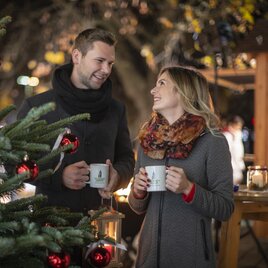 Young couple with mulled wine at the Advent market in Feldbach