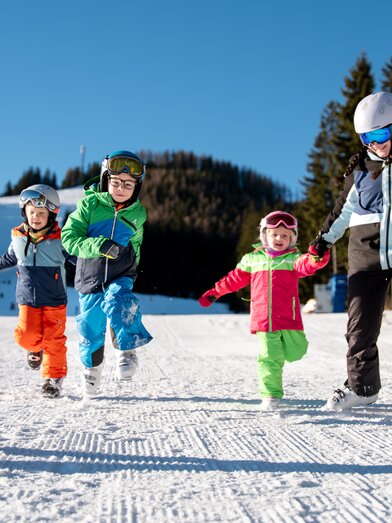 Kinder genießen einen schneebedeckten Skitag | ©  Oststeiermark Tourismus | Cian J. Baumgartner