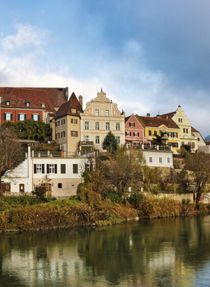 Ein Blick auf die farbenfrohe Flussstadt mit historischen Gebäuden.
