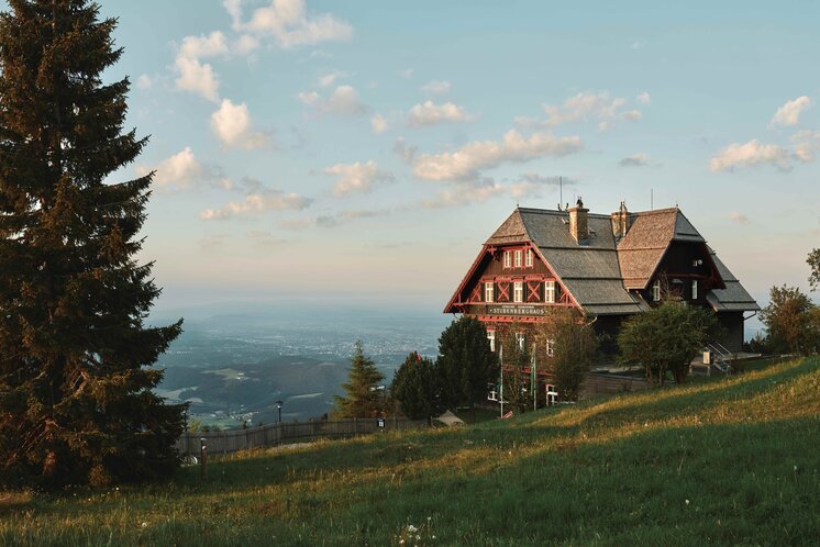 Stubenberghaus on the Schöckl, Graz’s local mountain, surrounded by meadows with views over the rolling Styrian landscape