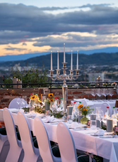 Elegantly set dinner table at the Vollmund Dinner on Schlossberg Graz with scenic view