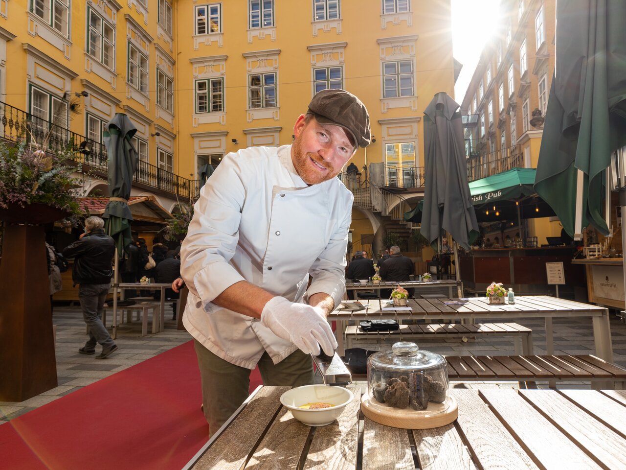 Chef presenting fresh truffles at the International Truffle Festival in a courtyard of Graz’s historic old town