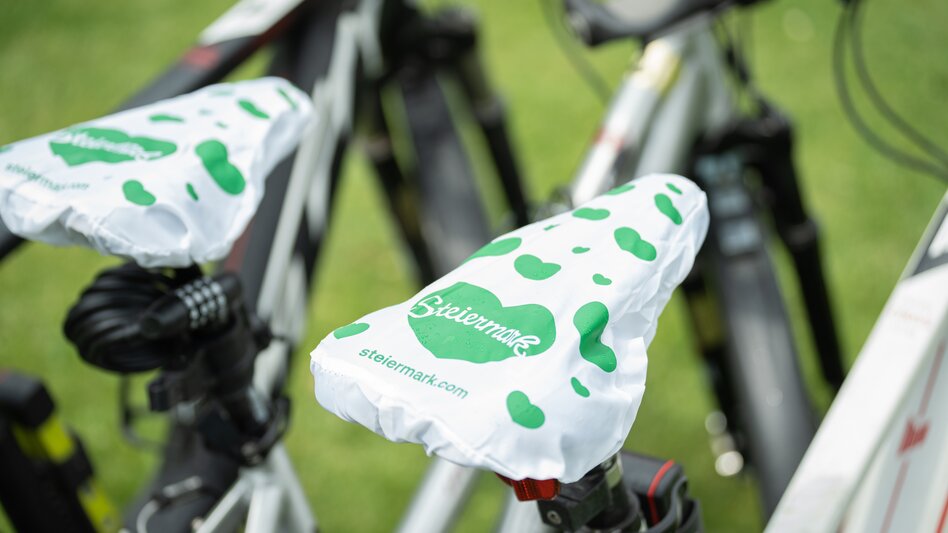 zwei Räder mit Radsattelschutz im Design der Steiermark - grüne Herzen auf weißem Untergrund - sind auf der Nahaufnahme zu sehen