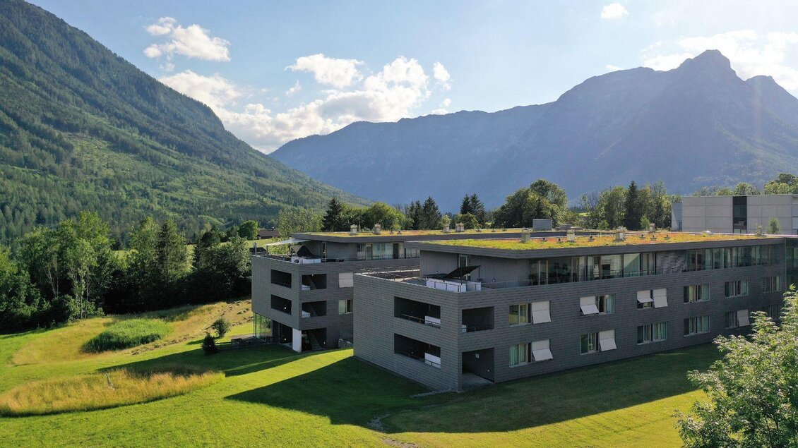Das AMEOS Klinikum in Bad Aussee umgeben von grünen Wiesen und ausseer Bergen. Die Sonne scheint auf das Gebäude und die Landschaft ist malerisch.</p> | © Ameos Klinika, Bad Aussee
