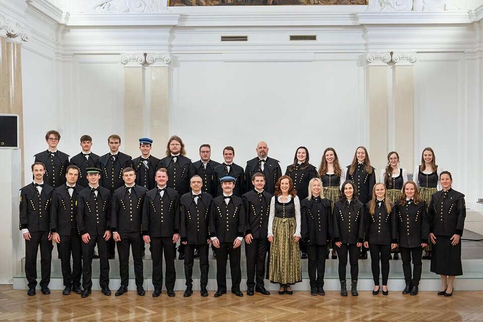 Eine Gruppe von Menschen in traditioneller Kleidung steht in einem Raum mit heller Dekoration. Sie lächeln und posieren zusammen für das Foto. | © Harald Tauderer