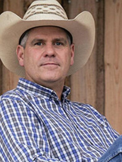 Bernd Hackl looks friendly and satisfied into the camera. He is wearing a checked shirt and a cowboy hat. | © Bernd Hackl