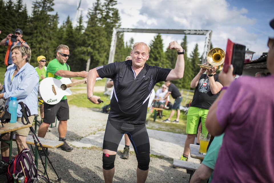 Eine Gruppe von Menschen feiert im Freien. Ein Mann tanzt begeistert, während andere mit Instrumenten musizieren. | © Die Edlseer/BePo