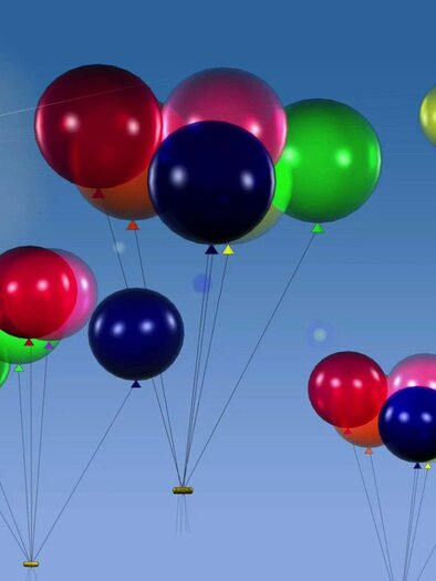 Colorful balloons float in front of a clear blue sky. The sun shines bright, creating a cheerful atmosphere. | © Pixabay