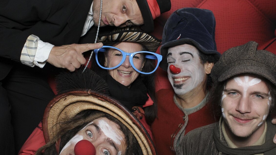 Eine Gruppe von Clowns posiert fröhlich für die Kamera. Sie tragen bunte Kostüme und Schmincke, während sie in die Kamera lächeln. | © Tourismusverband Oststeiermark
