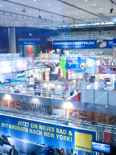 A large fair with many booths and exhibitors. The layout is well-lit and features various brands and products. | © Messe