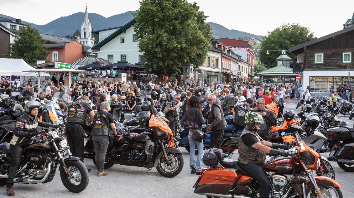 Eine große Menschenmenge versammelt sich auf einer Straße mit vielen Motorrädern. Die Atmosphäre ist lebhaft und es gibt eine festliche Stimmung. | © Harald Steiner