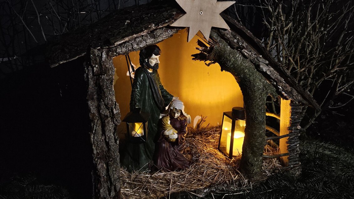 Eine Krippe mit Figuren von Maria und Josef in einem Stall aus Holz. Sanftes Licht leuchtet die Szene aus und stellt die Weihnachtsstimmung dar. | © Marktgemeinde Halbenrain
