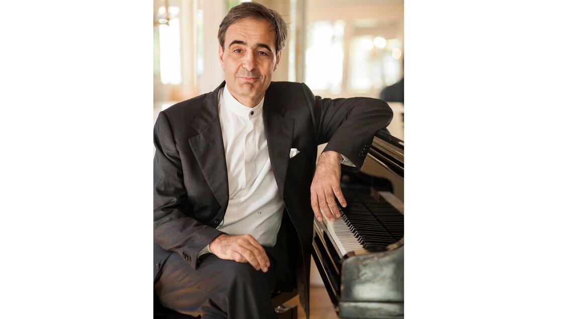 <p>Paul Gulda sitzt neben einem Klavier. Er schaut freundlich und entspannt in die Kamera.</p> | © J. Gradegger