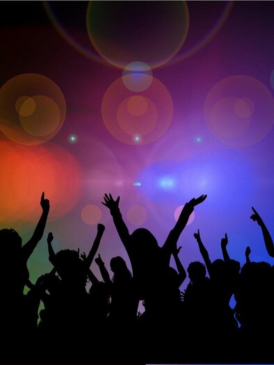 Ein Orchester spielt live auf einer Bühne. Die Musiker sind in weißen Kleidern gekleidet und konzentrieren sich auf ihre Instrumente. | © pixabay