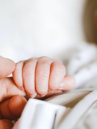 Eine sanfte Berührung zwischen einem Erwachsenen und einem Baby. Die kleine Hand des Babys greift den Finger des Erwachsenen. | © Bild: Pexels