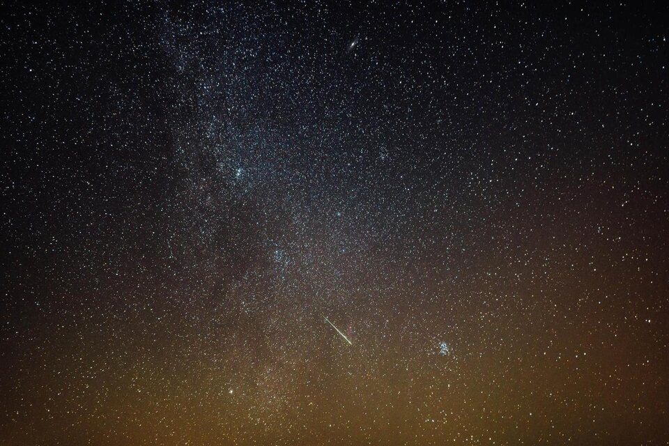 Ein klarer Nachthimmel mit einer Vielzahl von leuchtenden Sternen und der Milchstraße. Ein heller Meteor zieht durch das Bild. | © Schifffahrt Grundlsee Toplitzsee