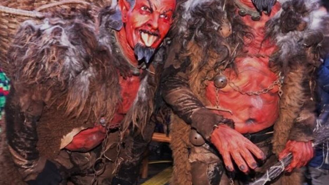 Zwei maskierte Figuren in schaurigen Kostümen stehen nebeneinander. Beide tragen rote Gesichtsmalerei und furchterregende Accessoires. | © Tourismusverband Oststeiermark
