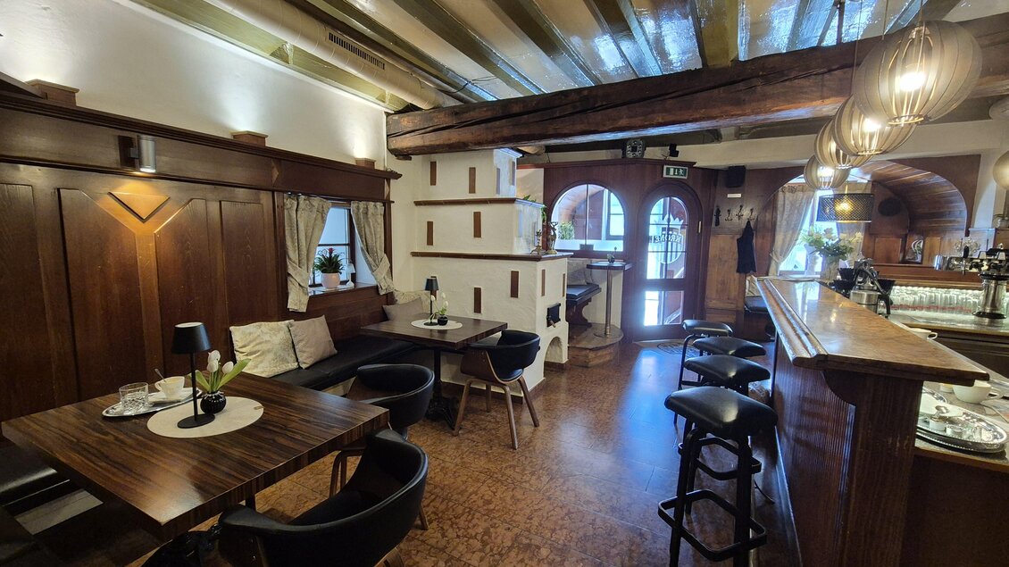 Eine gemütliche Innenansicht eines Restaurants mit Holzdekor. Die Tische sind gedeckt und eine Bar ist im Hintergrund sichtbar. | © TV Murau