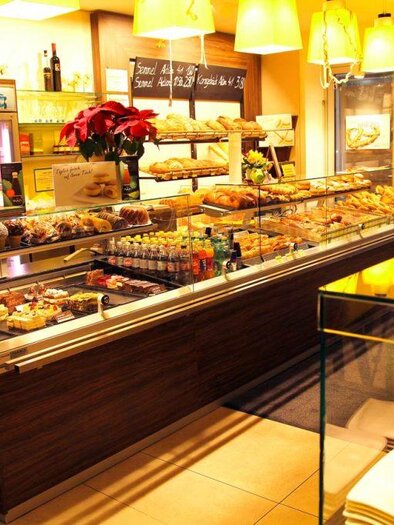 Eine einladende Café-Theke mit einer Auswahl an Kuchen und Gebäck. Die Atmosphäre ist gemütlich und hell, perfekt für eine entspannte Kaffeepause. | © Bäckerei Hütter