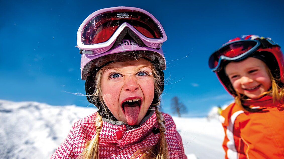 Kinder beim Grimassen schneiden auf der Piste. | © Familienschiberg St. Jakob im Walde
