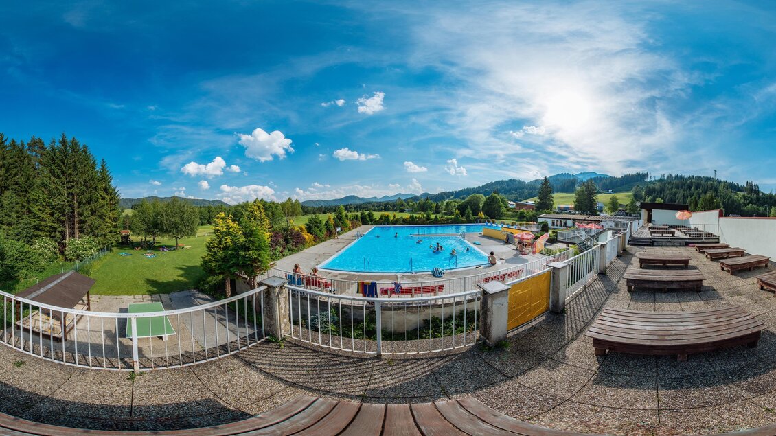 Ein Schwimmbad in einer malerischen Landschaft mit Bergen im Hintergrund. Die Atmosphäre ist einladend, ideal zum Entspannen und Schwimmen. | © TV Mitterbach