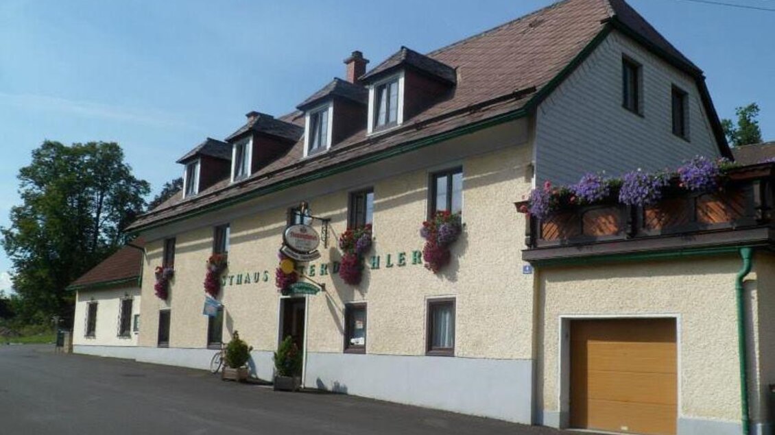 Ein traditionelles Gasthaus mit einer bunten Fassade und einem freundlichen Außenbereich. Das Bild zeigt einladende Fenster und eine gepflegte Umgebung. | © Gasthaus Unterdechler