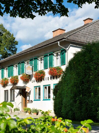Ein charmantes Haus mit grünen Fensterläden und Blumenkästen. Es steht in einer ruhigen, gepflegten Umgebung mit viel Grün. | © TV Region Graz - Rene Vidalli