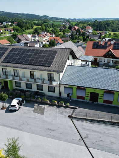 A bird's eye view of several buildings in a rural setting. The architecture is diverse, with a large courtyard and green spaces. | © Gasthaus Schwammer