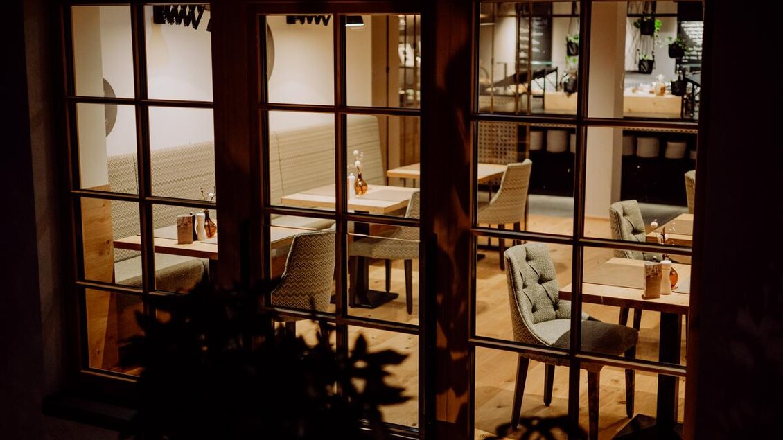 Ein gemütliches Restaurant mit einem modernen Innenraum. Tische und Stühle sind ordentlich angeordnet, und die Atmosphäre wirkt einladend. Es ist eine kleine Stube, das Riedeneck | © Karin Bergmann