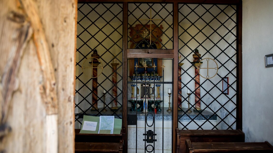 Eine kleine Kapelle mit einem Gitter und einem Altar im Hintergrund. Platz für Gebet und Besinnung. | © Anita Fössl