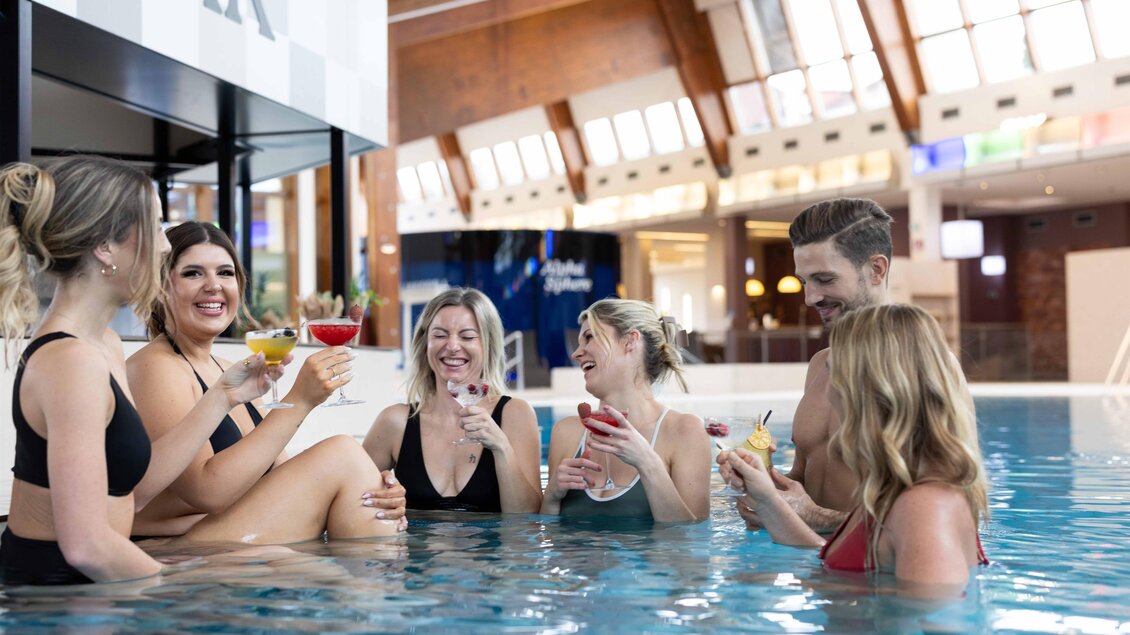<p>Eine Gruppe von sechs Personen steht im Wasser und hat Cocktails in der Hand. Sie lachen und genießen die Zeit in einer modernen Umgebung. Thermenresort Loipersdorf in Bad Loipersdorf.</p> | © TRL