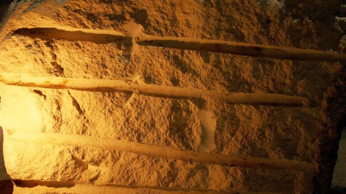 Ein großer, behauener Felsen mit mehreren horizontalen Einkerbungen. Die Oberfläche ist rau und gut beleuchtet. | © Stefan Matic