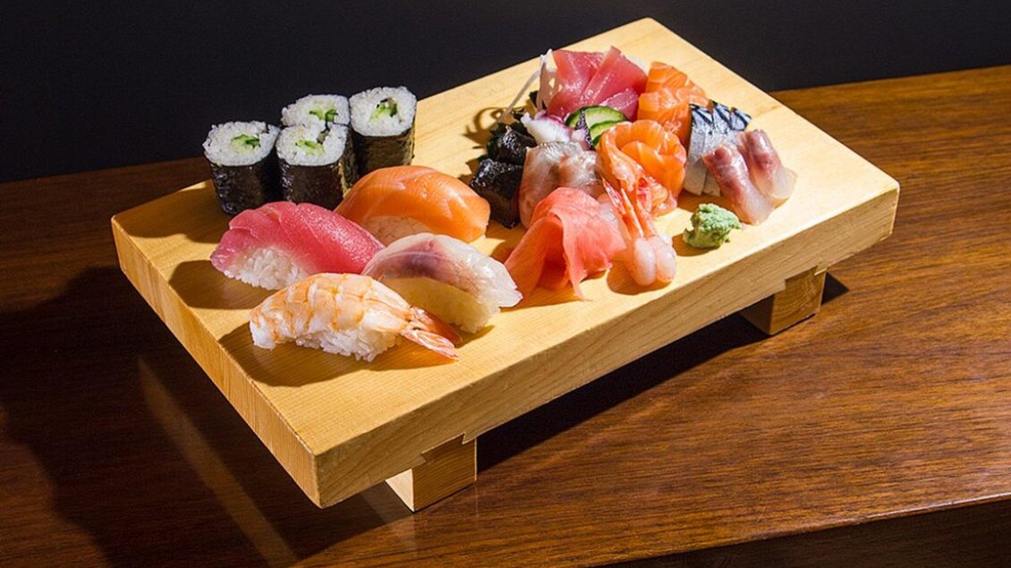 Eine schöne Sushi-Platte mit verschiedenen Sushi-Varianten und Makis. Die hochwertige Holzunterlage hebt die frischen Zutaten hervor. | © Yamamoto
