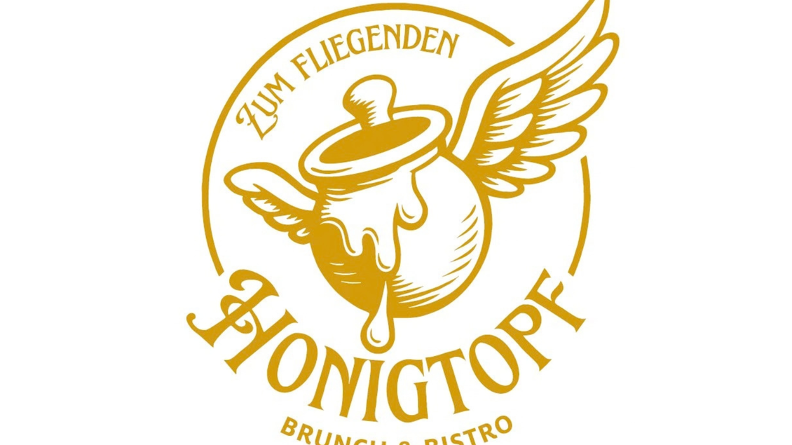 Das Logo vom Bistro und Brunch Spot „Zum fliegenden Honigtopf“ in Tauplitz zeigt genau solch einen fliegenden Honigtopf in Gelb. | © Zum fliegenden Honigtopf