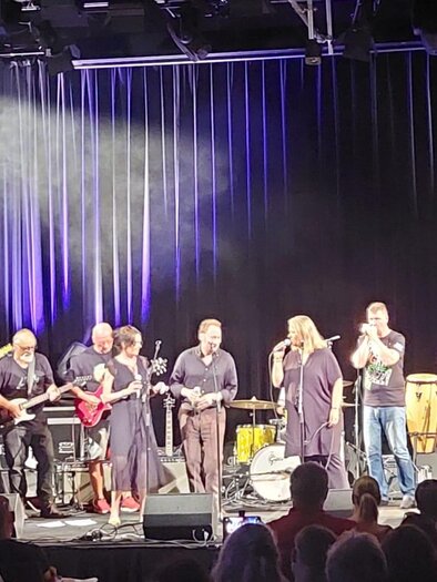 A live band is playing on a stage with several musicians and instruments. The atmosphere is lively and there are colorful lights in the background. | © Kulturforum Bad Radkersburg