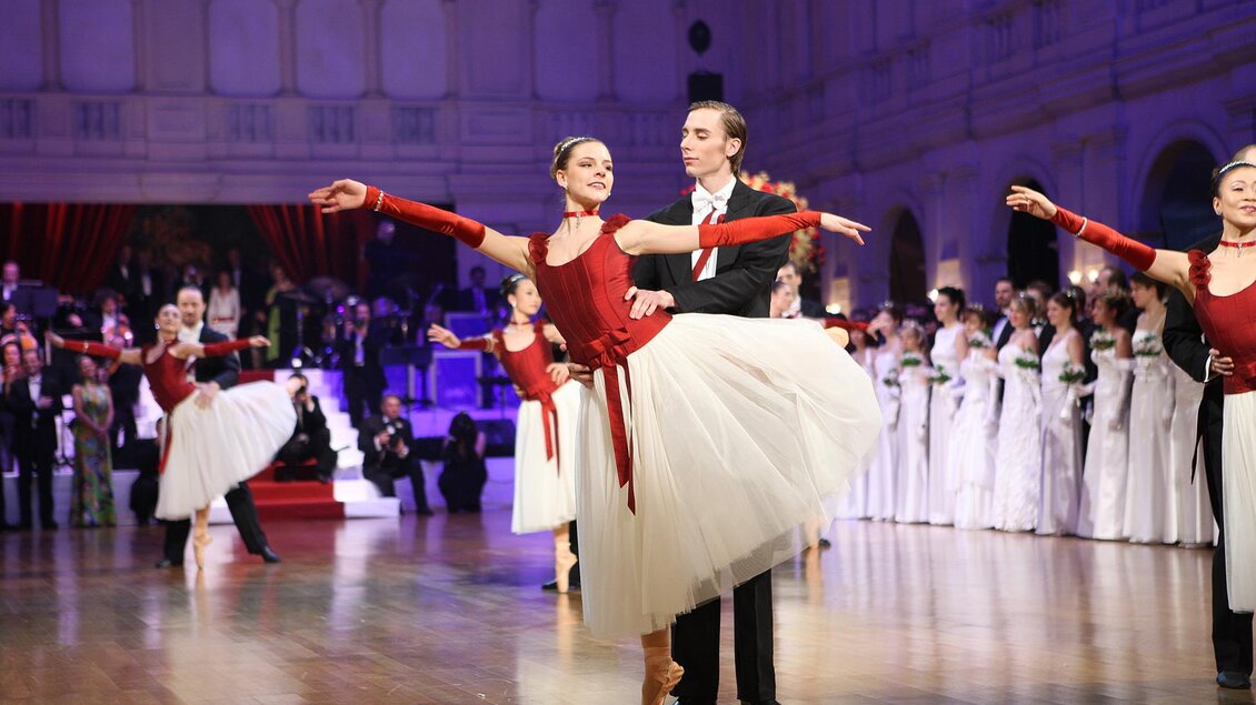 Ein eleganter Balletttanz in festlicher Atmosphäre. Tänzer in roten und weißen Kostümen präsentieren eine beeindruckende Darbietung. | © Mafija Kanizaj