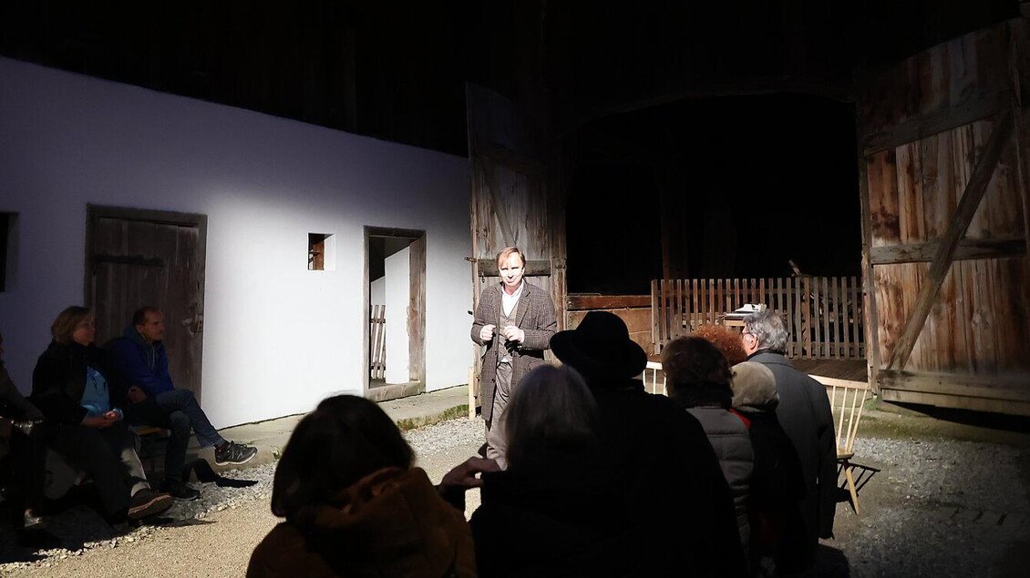 Eine Person spricht vor einem Publikum in einem geschlossenen Raum. Die Zuschauer sitzen auf Stühlen und schauen gespannt zu. | © ÖFM